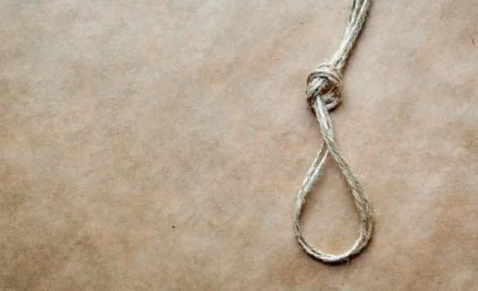 creative image of a noose on a rough brown background