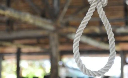 Loop of rope hanging on a wooden background