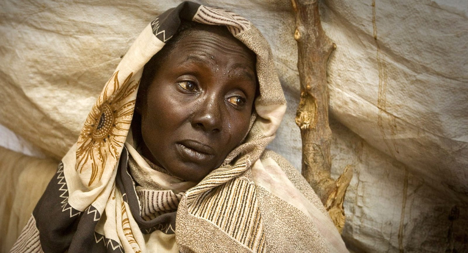 A woman from South Kordofan Sudan in a displaced camp, crying.