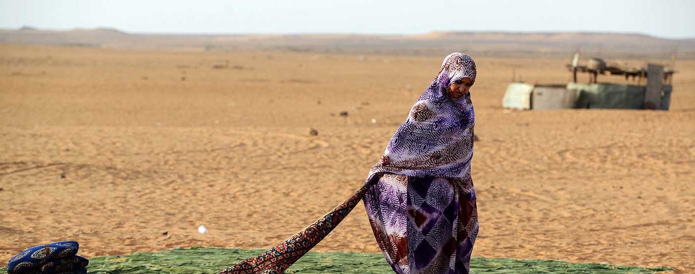 A Sahrawi refugee stands on a rug at the Sahrawi refugee camp of Dakhla