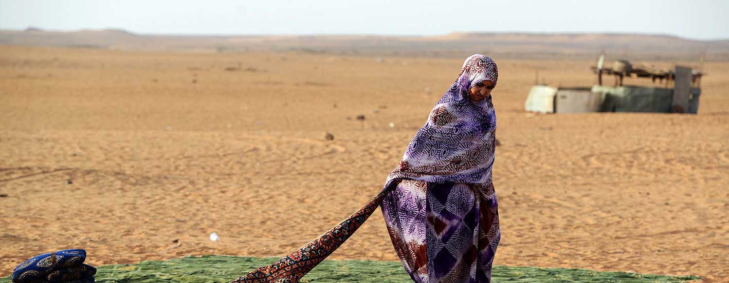 A Sahrawi refugee stands on a rug at the Sahrawi refugee camp of Dakhla