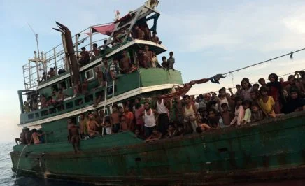 Rohingya migrants sit and stand on a boat drifting in Thai waters off the southern island of Koh Lipe in the Andaman sea on May 14, 2015. A boat crammed with scores of Rohingya migrants -- including many young children -- was found drifting in Thai waters on May 14, with passengers saying several people had died over the last few days.