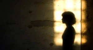 A woman's silhouetted shadow against a wall