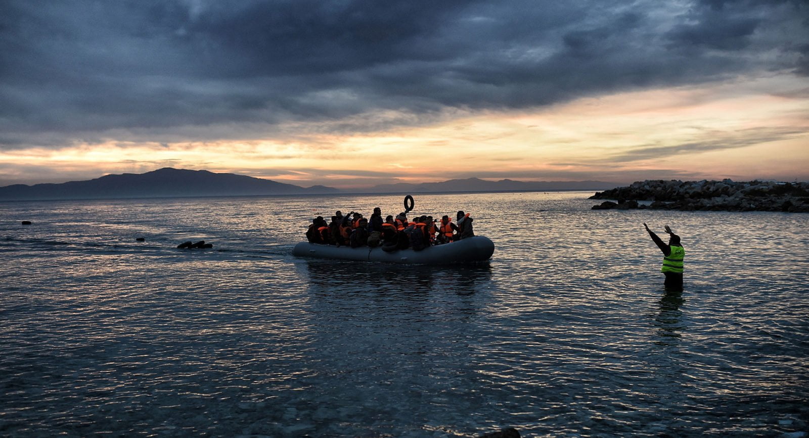 Refugees and migrants on an inflatable boat reach Mytilene, Greece.