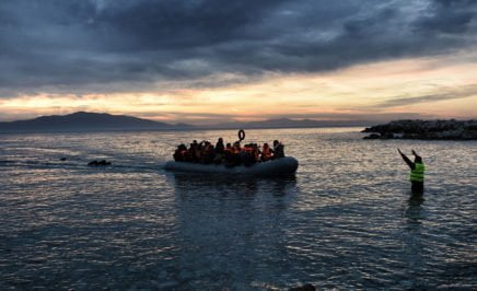 Refugees and migrants on an inflatable boat reach Mytilene, Greece.