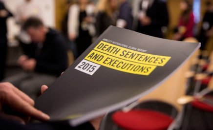 Hand holding printed copy of Amnesty's 2015 Death Penalty report
