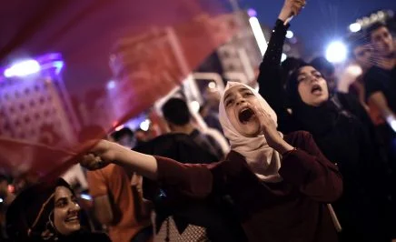 Supporters gather at Taksim square in Istanbul, waving flags and shouting to support the government following a failed coup attempt.