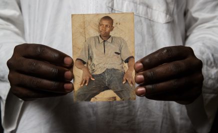 A man holds a photograph