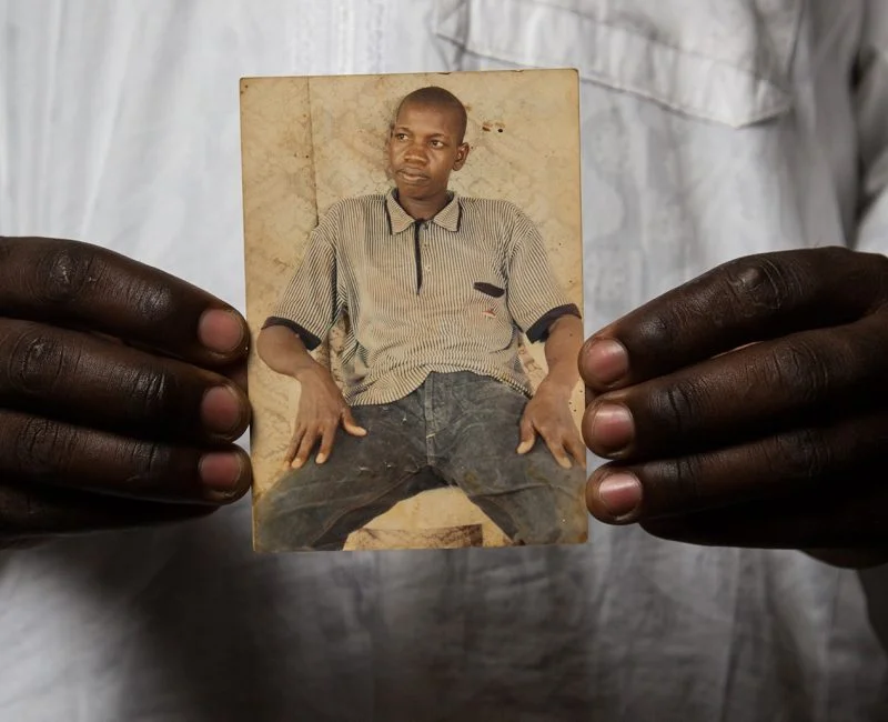 A man holds a photograph