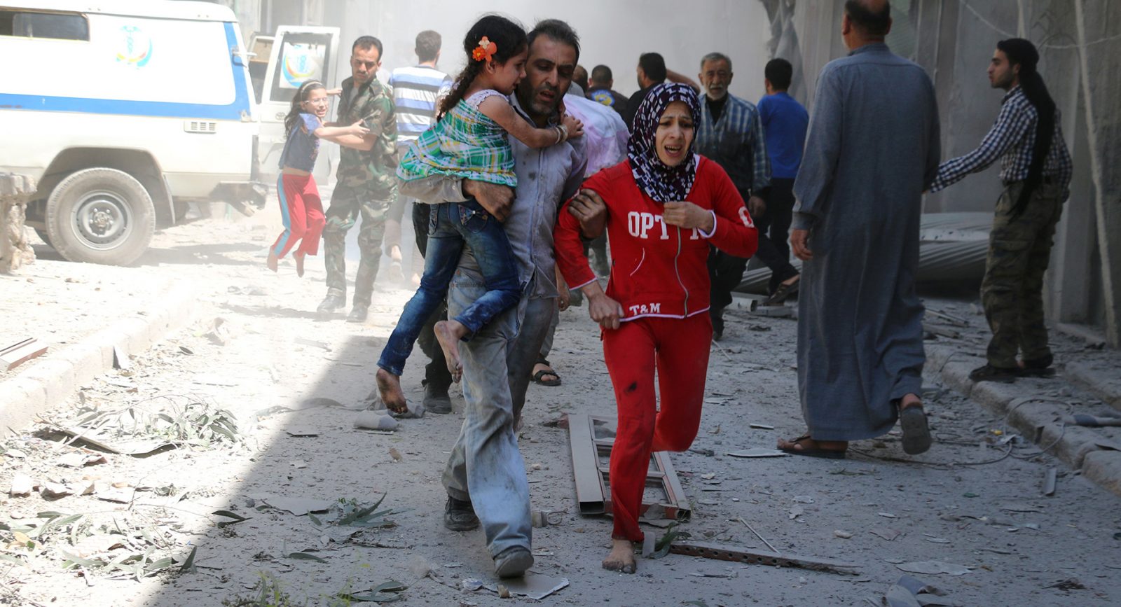 A family run through rubble in Syria searching for safety