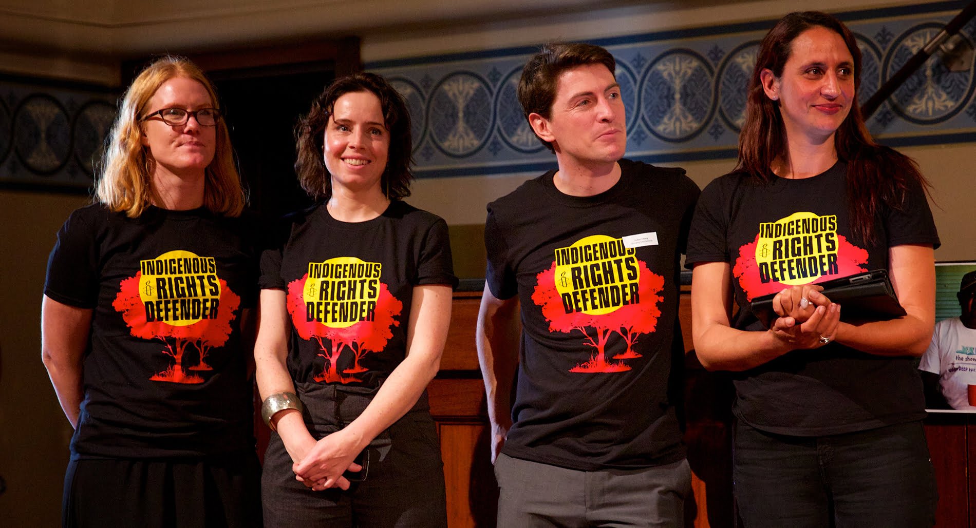 Amnesty campaigners wearing 'Indigenous rights defender' shirts