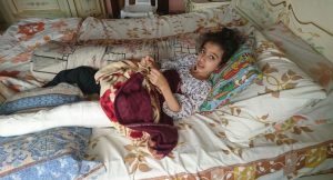 Ghina Ahmad Wadi, a young girl lying in bed