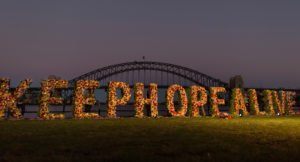 Large wreaths spell out '#KeepHopeAlive' in front of the Sydney Harbour Bridge at a vigil for people at risk of execution in 2015.