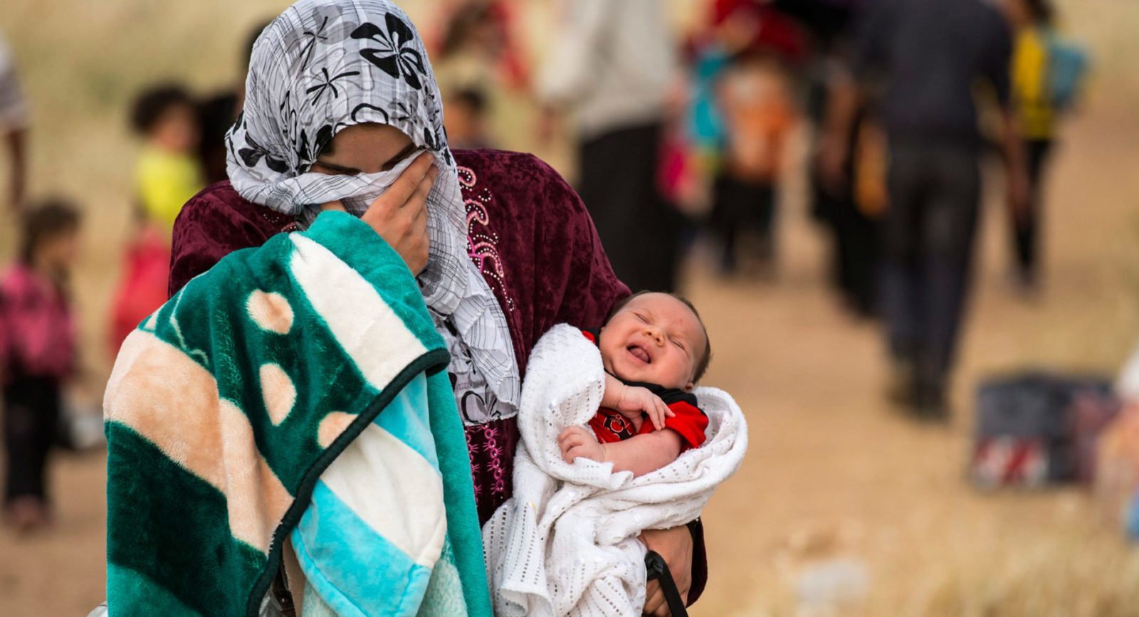 A young mother fleeing Syria with her baby