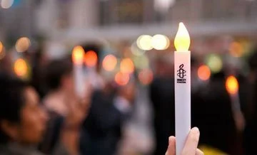Close up of an Amnesty candle at a vigil