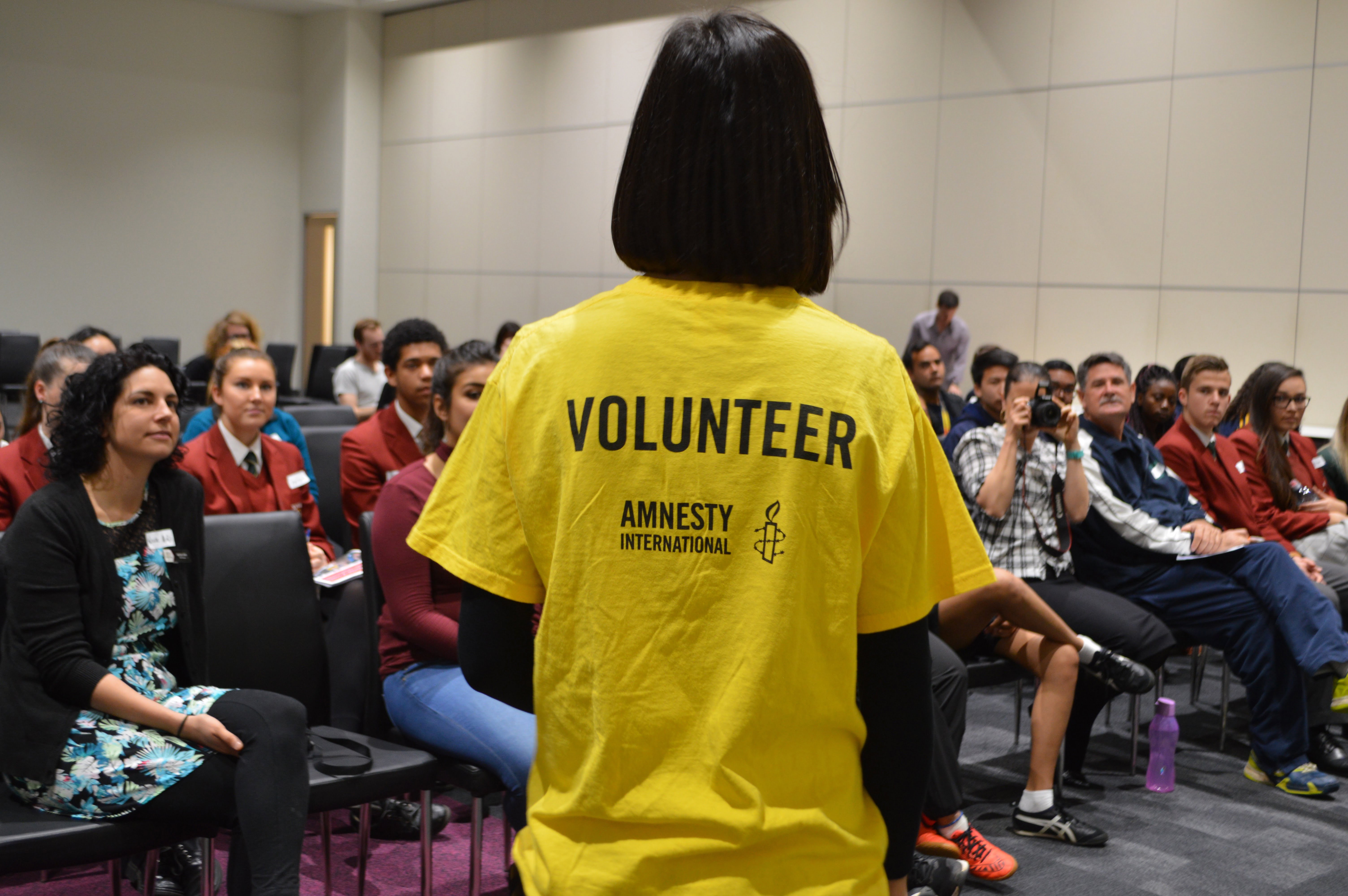 An Amnesty volunteer with students at the SA/NT Schools Congress. © Private