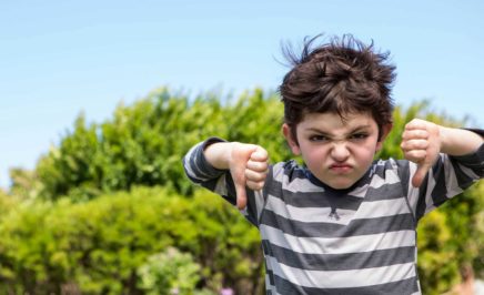 Boy giving thumbs down