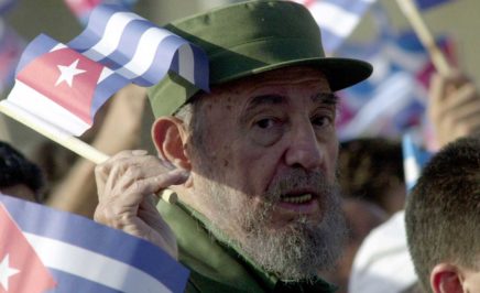 Former Cuban President Fidel Castro waves a Cuban flag