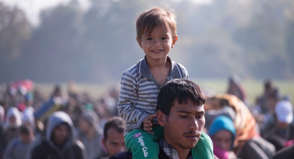 A boy on the shoulders of his father