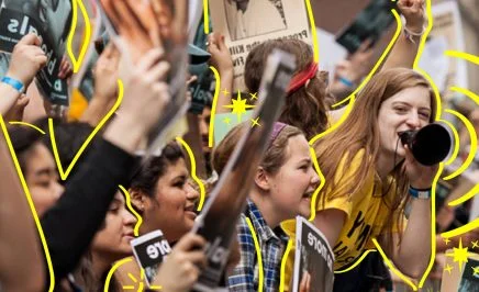 A line of young impassioned women protesting at a rally with raised fists and megaphones. The women are outlined by yellow lines.