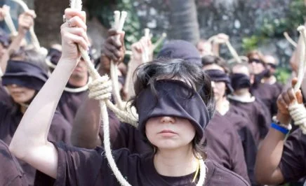 Amnesty protester wear blindfolds and hold a noose
