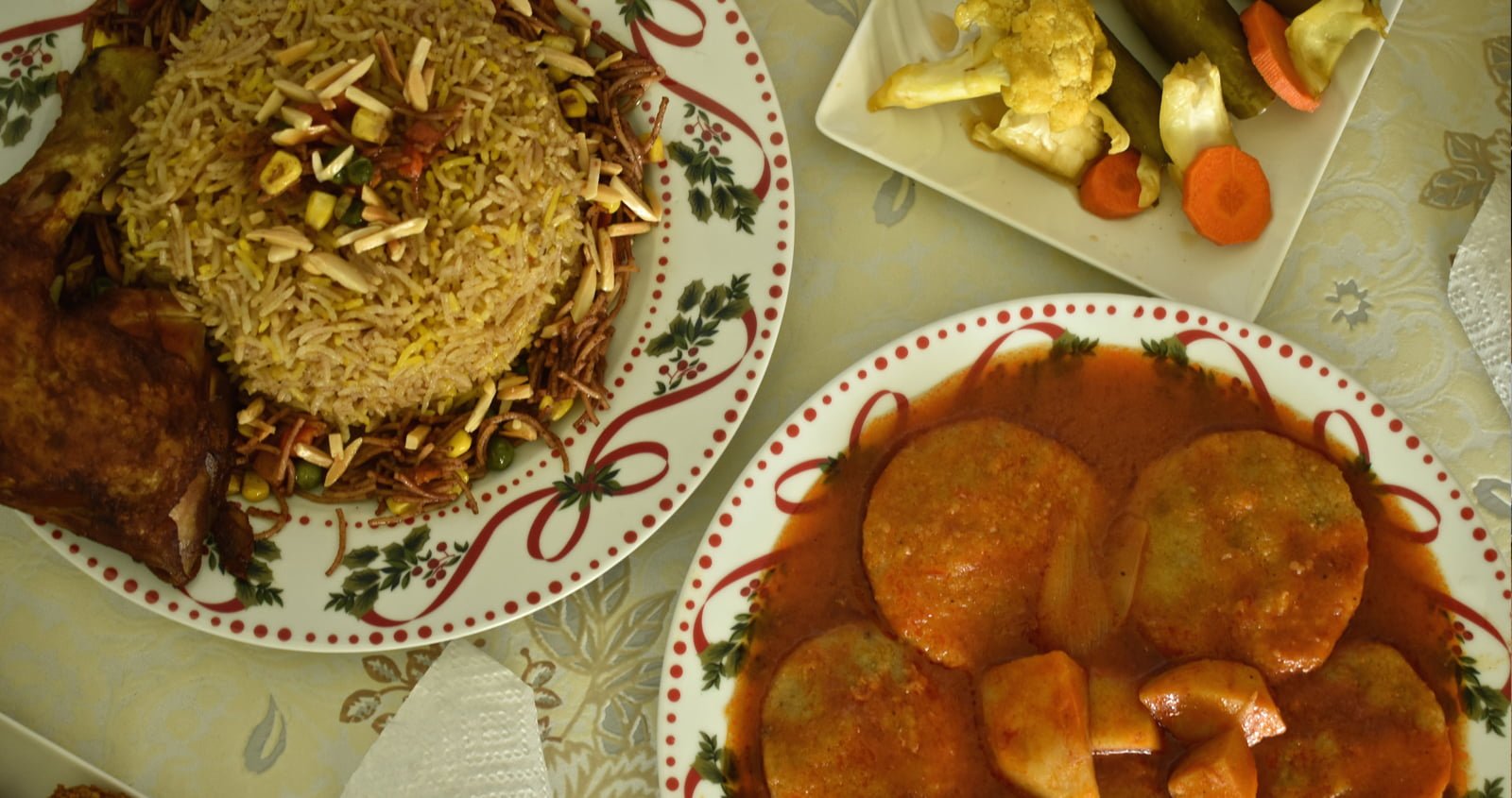 A plate of Biryani with side dishes of vegetables