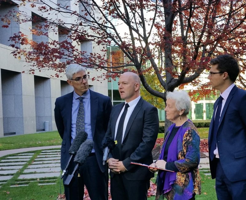 Sister Jane stands on a lawn in the courtyard at parliament house, Canberra, and delivers a speech about the men on Manus Island