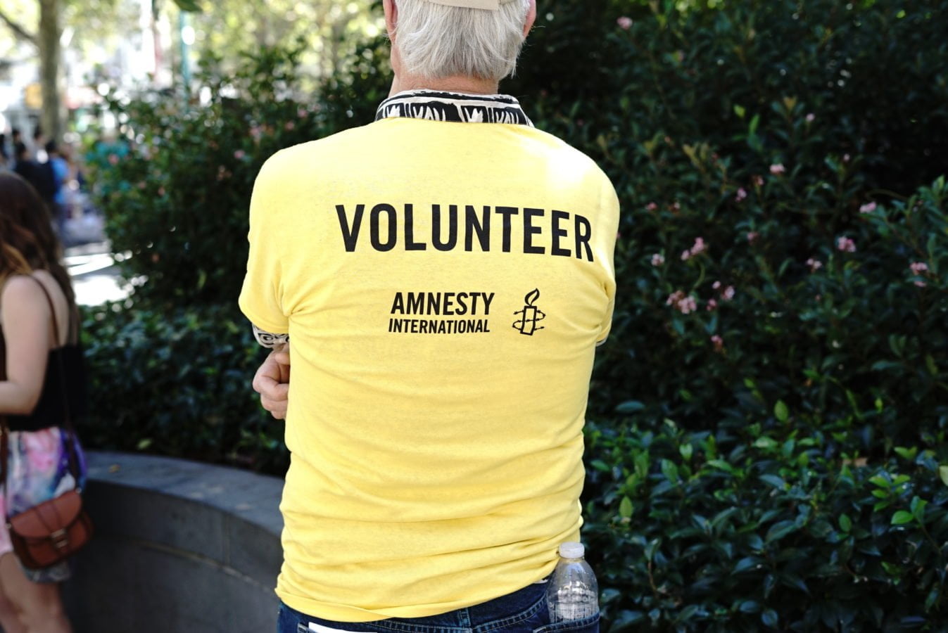 Volunteer wearing a yellow amnesty shirt