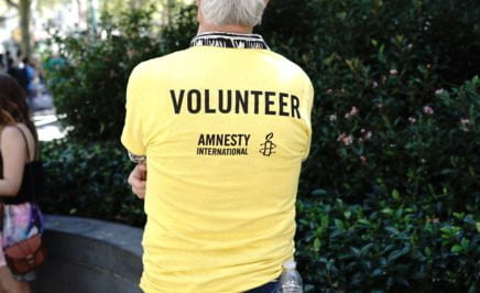 Volunteer wearing a yellow amnesty shirt