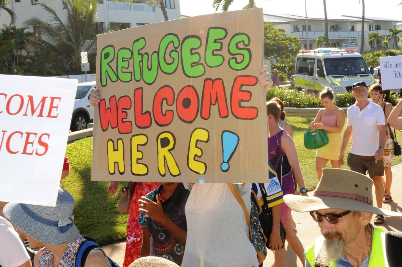 Homemade banner from the Palm Sunday refugee rally in Townsville. Colourful cardboard banner states 'Refugees welcome here'.