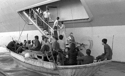 Vietnamese refugees prepare to come aboard the USS BLUE RIDGE