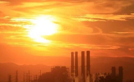 image of a factory with gas omissions pollution towers sunset