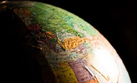 A close up photo of a globe set against a black background