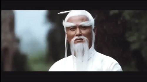An animated gif of the character Pei Mei from 'Kill Bill' thoughtfully stroking his long white beard.