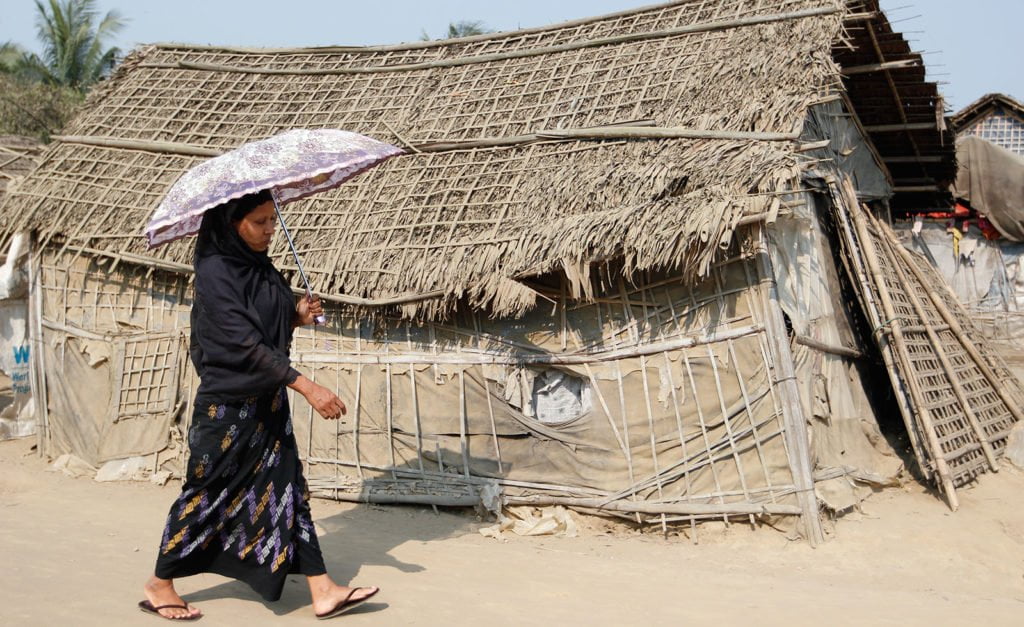 A Rohingya woman shields herself from the sun in the displacement camps outside Sittwe township, Rakhine State, Myanmar
