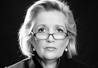 black and white image of a womans face with glasses and grey chin length hair