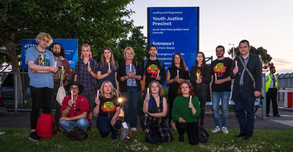 Amnesty activists attend a candlelit vigil outside a Youth Justice Precinct in Victoria as part of the Community is Everything Blitz