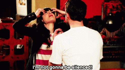 An animated gif of Zooey Deschenel in New Girl throwing her hands in the air and shouting 'I'm not gonna be silenced!'