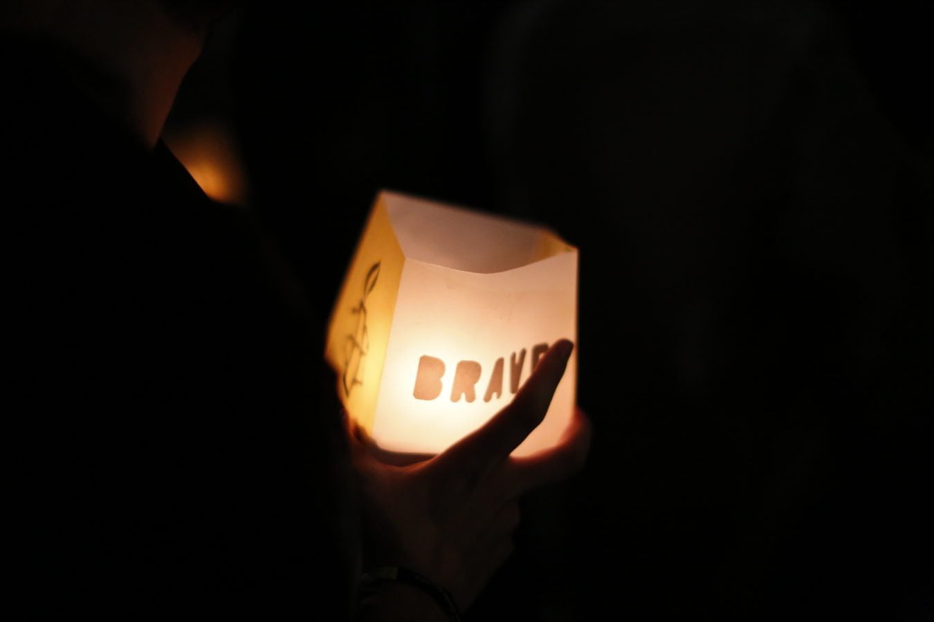 An illuminated lantern spelling brave at an Amnesty International Portugal stunt to free rights defenders in Turkey