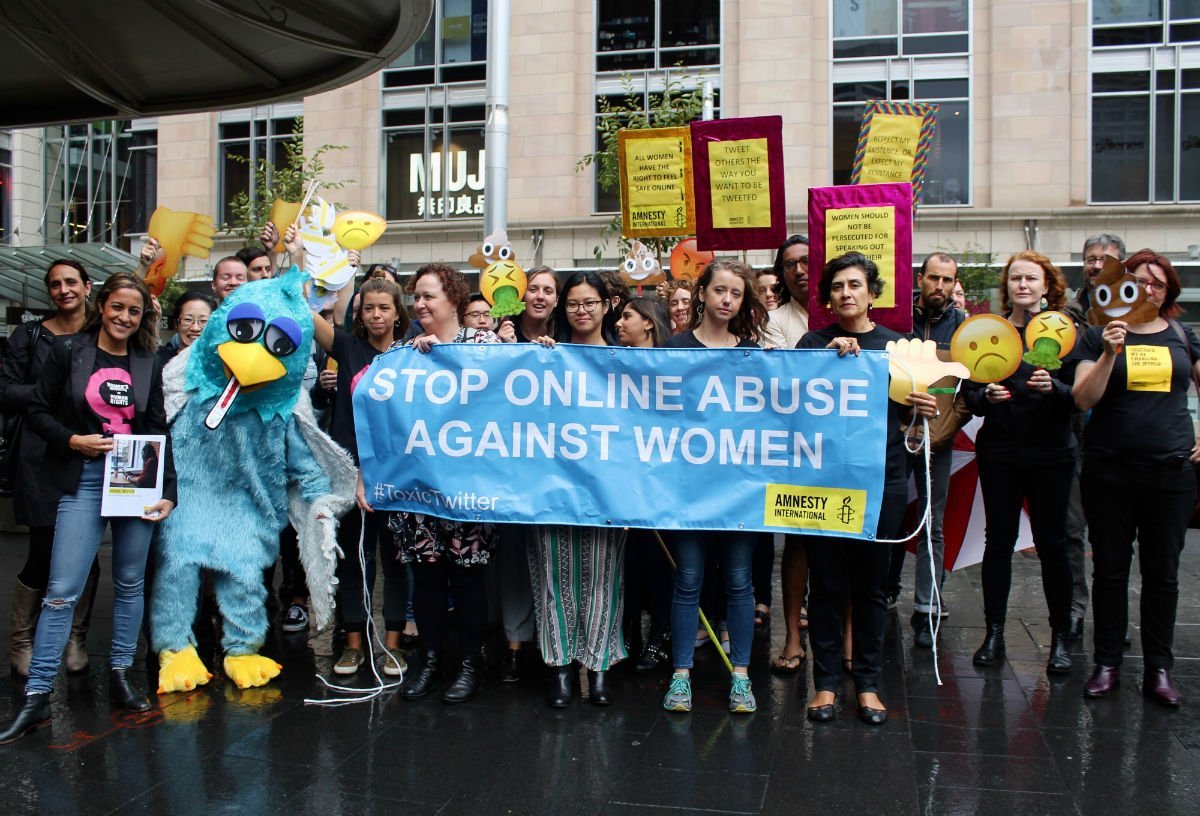 Amnesty staff and activists with banners and props targeting Twitter on online abuse of women