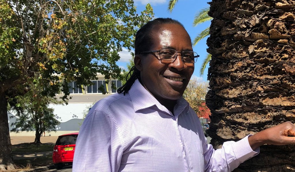 Felix Machiridza smiling next to a tree