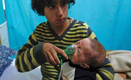 A Syrian boy holds an oxygen mask over the face of an infant at a make-shift hospital following a reported gas attack in Eastern Ghouta.