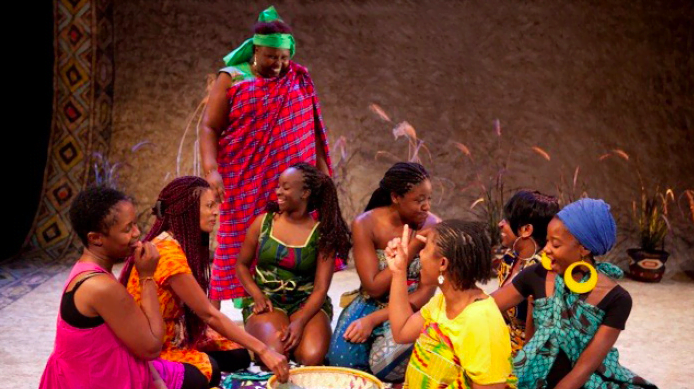a group of women in brightly coloured clothing sitting together