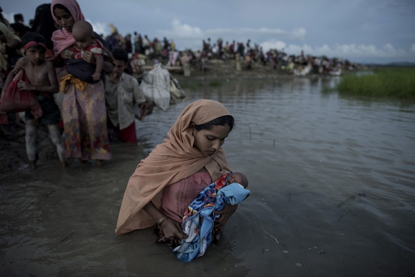 A Rohingya mother holds her baby in her arms