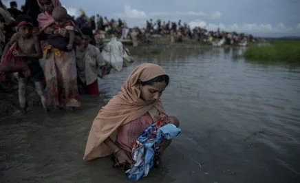 A Rohingya mother holds her baby in her arms