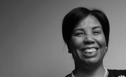 Black and white photo of Azza Soliman smiling into the camera.