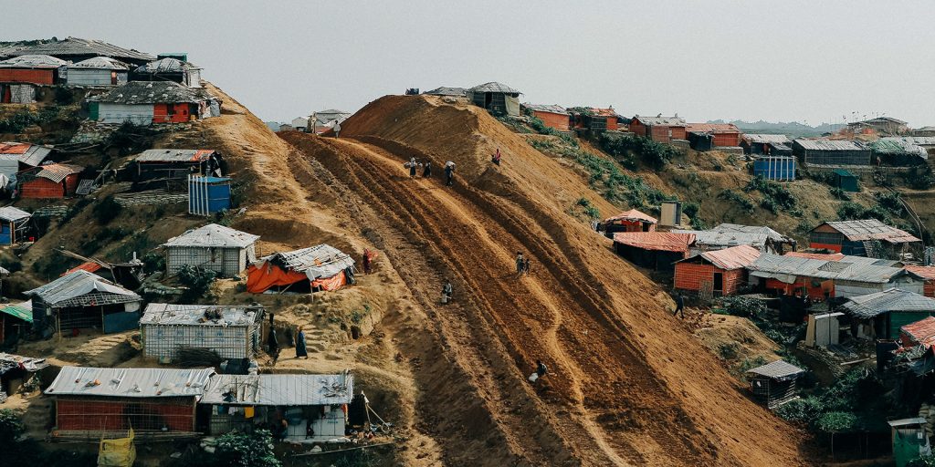 A photo of makeshift refugee shelters clinging to a hillside in Bangladesh.