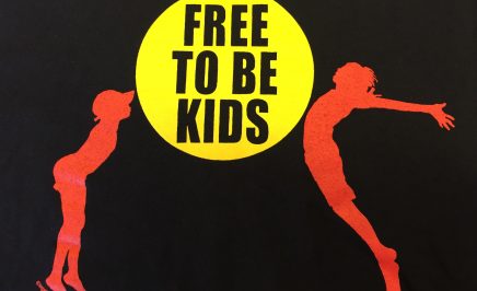 A silhouette of two kids jumping in the air, one on each side of a yellow circle which has the wording 