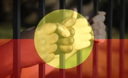 Children's hands with Indigenous Flag overlay