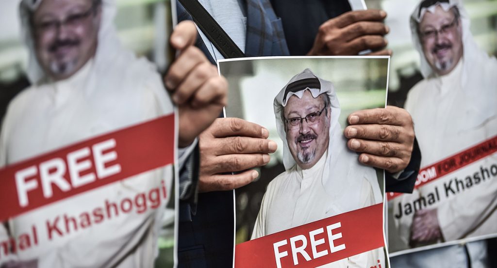 Protestors hold pictures of missing journalist Jamal Khashoggi during a demonstration in front of the Saudi Arabian consulate on 8 October 2018.